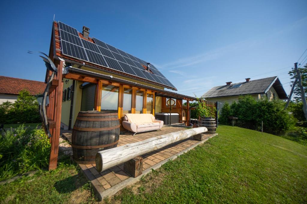 a house with a solar roof on a lawn at Nebesa so tudi na zemlji in Tomaž pri Ormožu