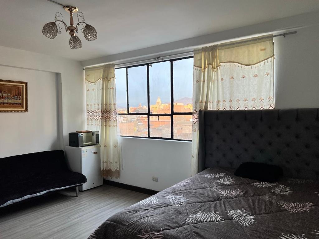 a bedroom with a bed and a large window at Most Central Place in Lima in Lima