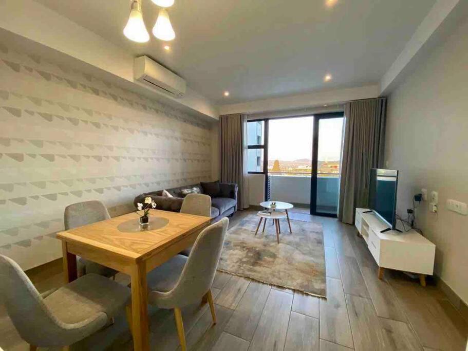 a living room with a table and chairs and a couch at Luxury 1-bedroom Apartment With DSTV and Wi-Fi in Pretoria