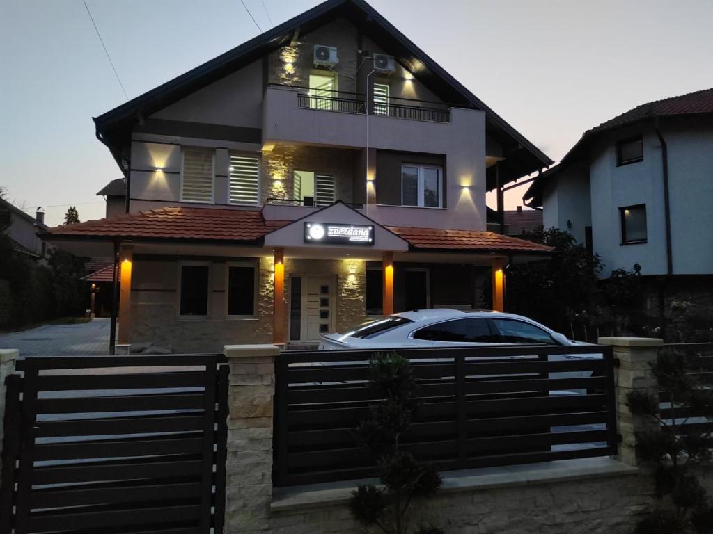 a house with a car parked in front of it at Apartmani Zvezdana in Vrnjačka Banja