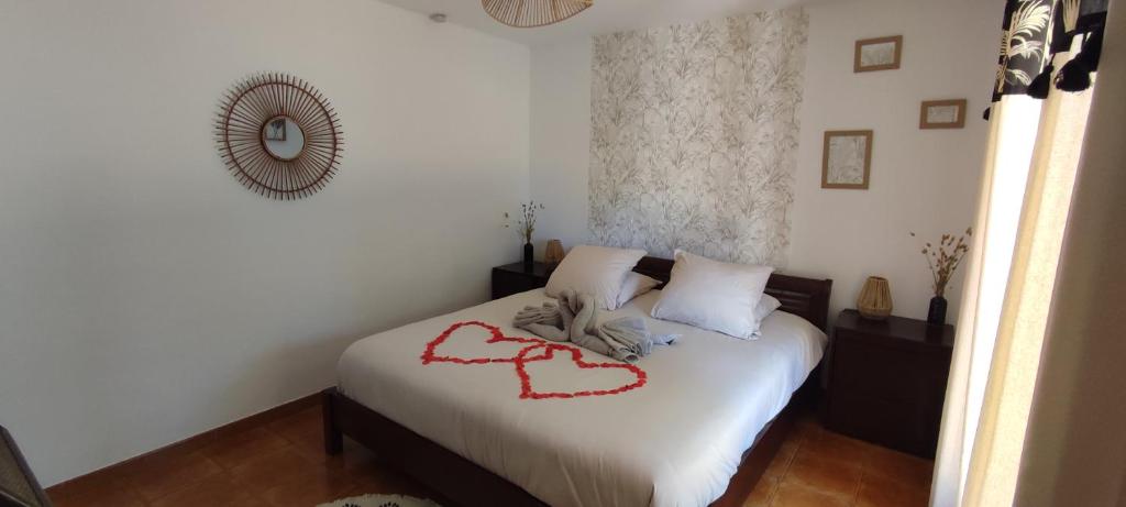 a bedroom with a bed with a heart drawn on it at Chambre d&#39;hôte Amouratcha in Fabrègues