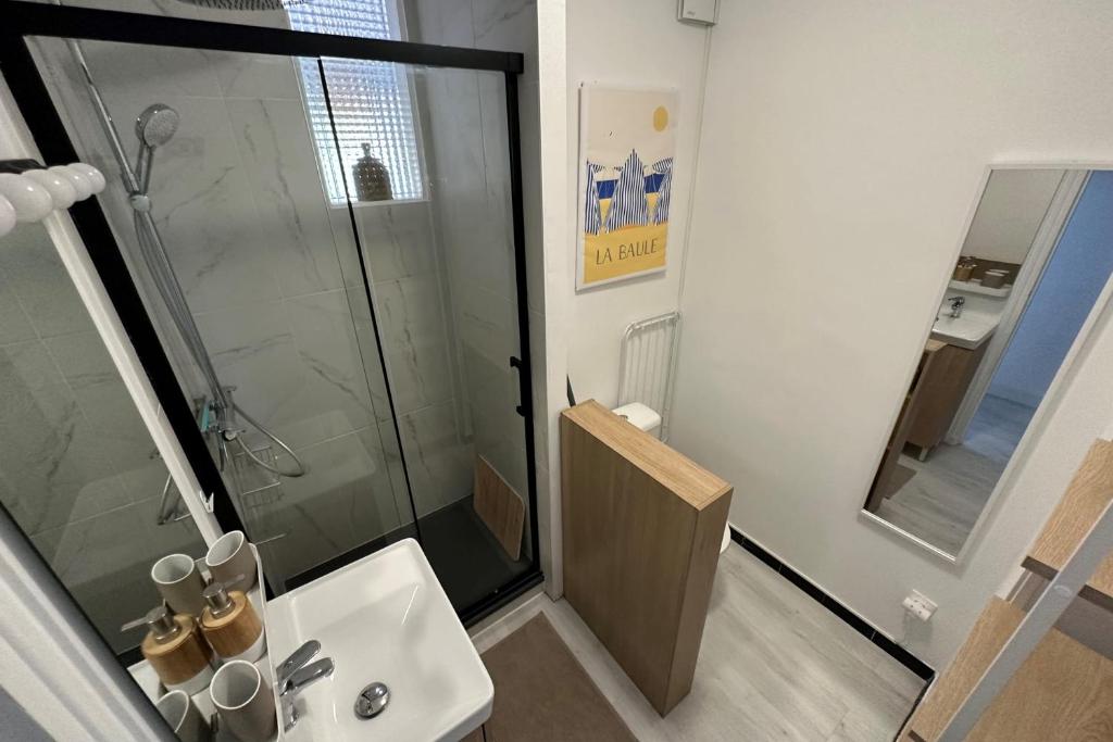 a bathroom with a glass shower and a sink at Studio with balcony - 2 min beach and AquaBaule in La Baule