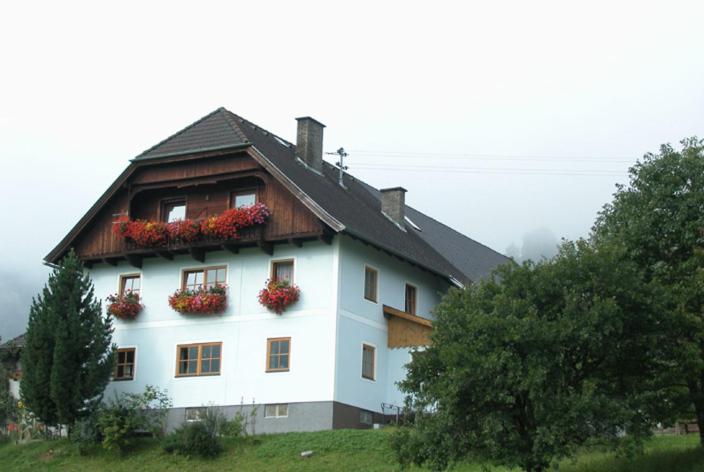 a large white house with flower boxes on it at Ferienwohnung Boahof in Lessach