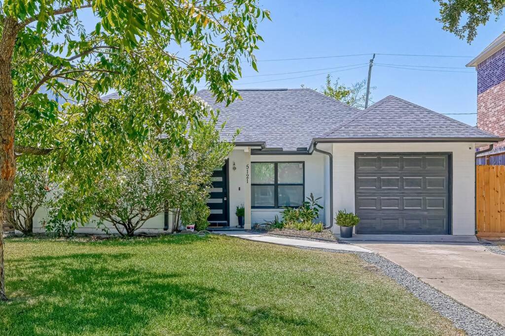 a house with a garage at Stylish, 2 Bedroom in Houston-Bellaire in Houston