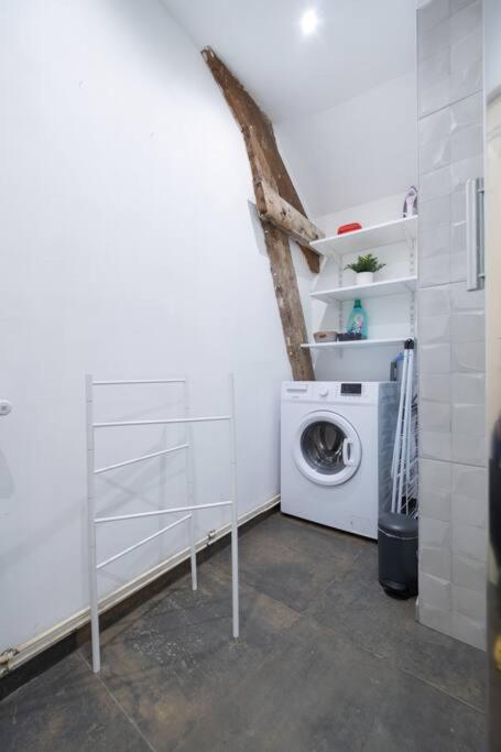 a white laundry room with a washing machine in it at Spacy Rock in Reims