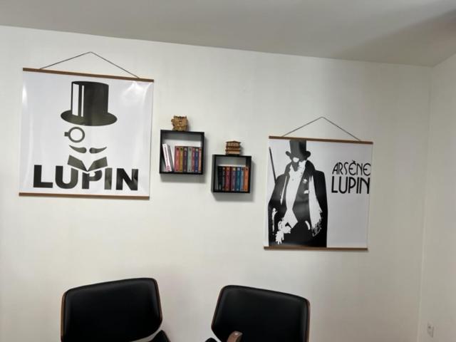 a wall with two chairs and a graduation hat on it at Captain YOO - Antre de Lupin - Relevez le défi ! in Fécamp