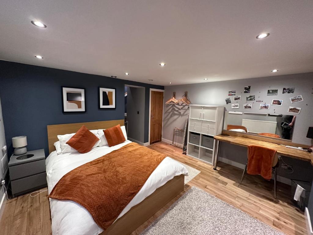 1 dormitorio con 1 cama grande y escritorio en Apple Street Cottage, en Oxenhope