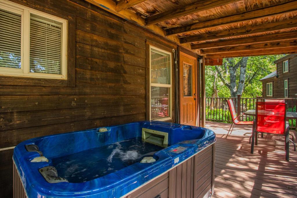 a large blue tub sitting on a porch at Fig Cabin in Fredericksburg