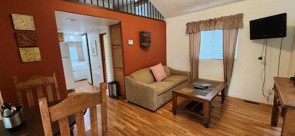 a living room with a couch and a table at Fig Cabin in Fredericksburg