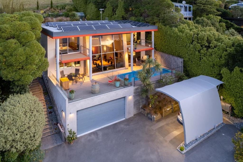 an overhead view of a house with solar panels on the roof at The Bolthole - Charteris Bay Holiday Home in  Lyttelton
