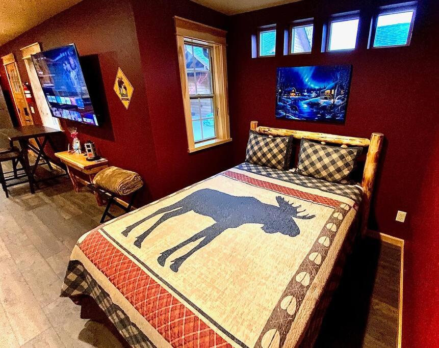 a bedroom with a bed with a picture of a deer on it at Cedar Mountain -Suite C in Grants Pass
