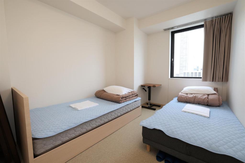 Postel nebo postele na pokoji v ubytování Tokyo Ueno Youth Hostel