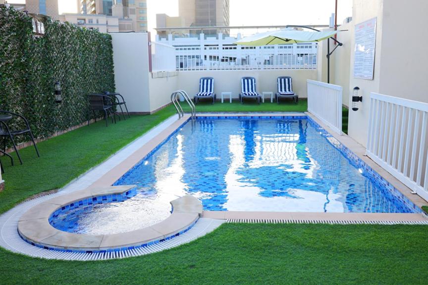 a large swimming pool on the roof of a building at THE K HOTEL in Dubai