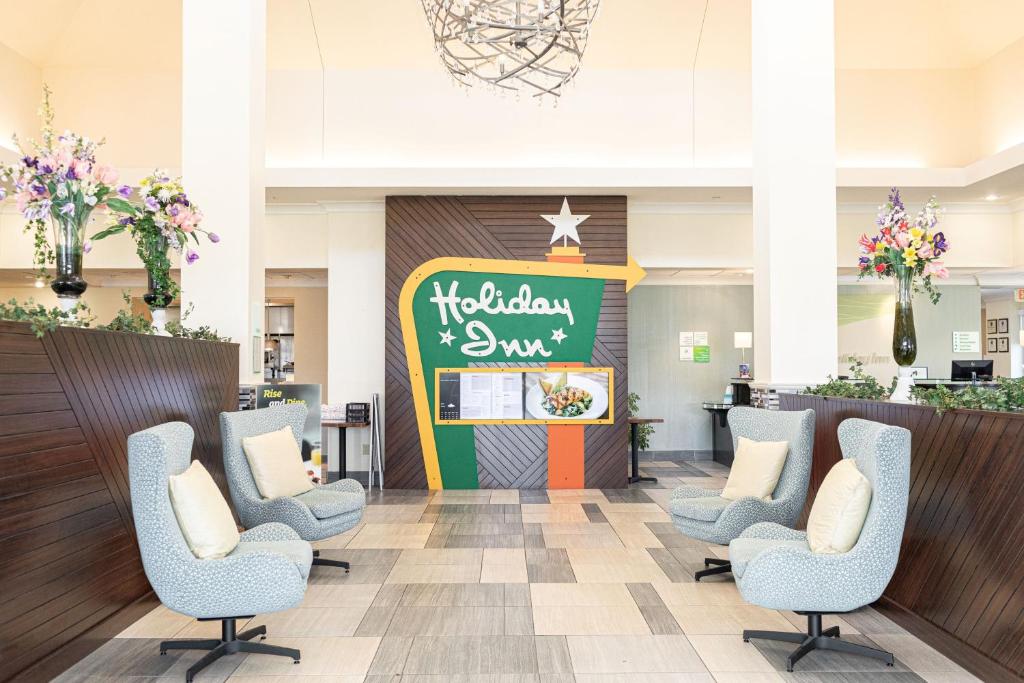 a waiting room at a hospital with chairs and a chalkboard at Holiday Inn Effingham, an IHG Hotel in Effingham