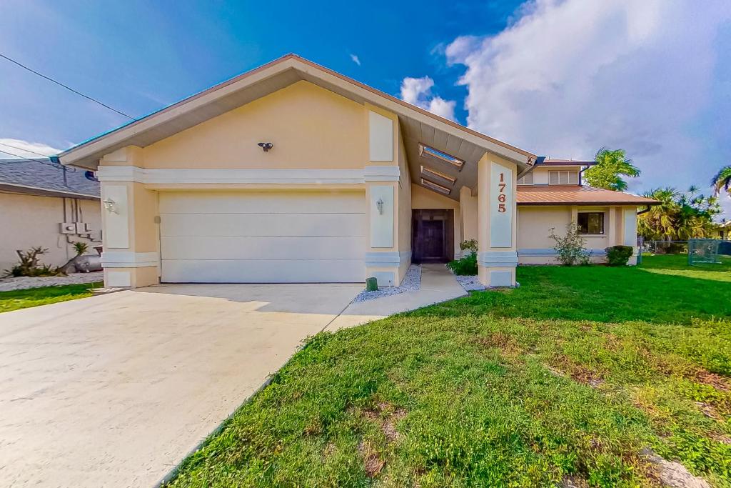 a large house with a garage at Palms on the Canal in Cape Coral