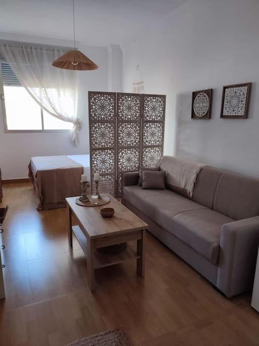 a living room with a couch and a table at Portamar estudio 312 in Almuñécar