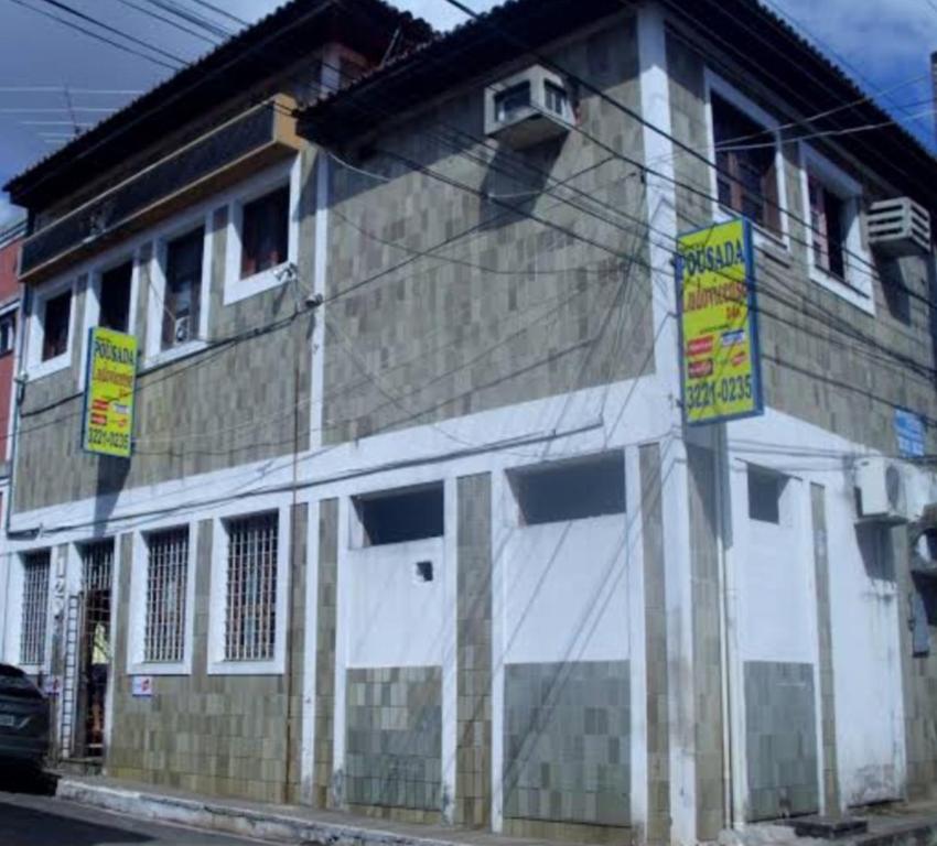a building with signs on the side of it at Pousada Nova Ludovicense in São Luís