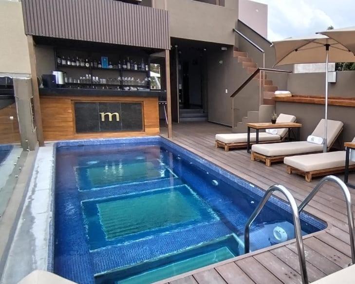 a swimming pool in the middle of a house at Hotel Madi in San Miguel de Allende