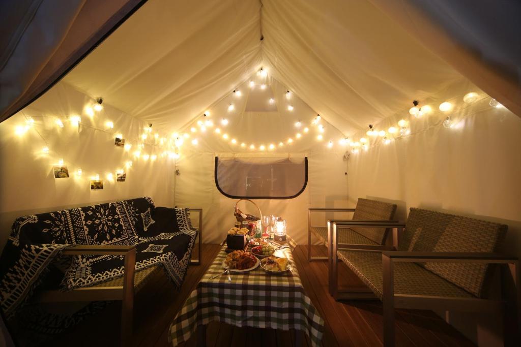 a room with a tent with lights and a table at Hound Hotel Minam in Busan