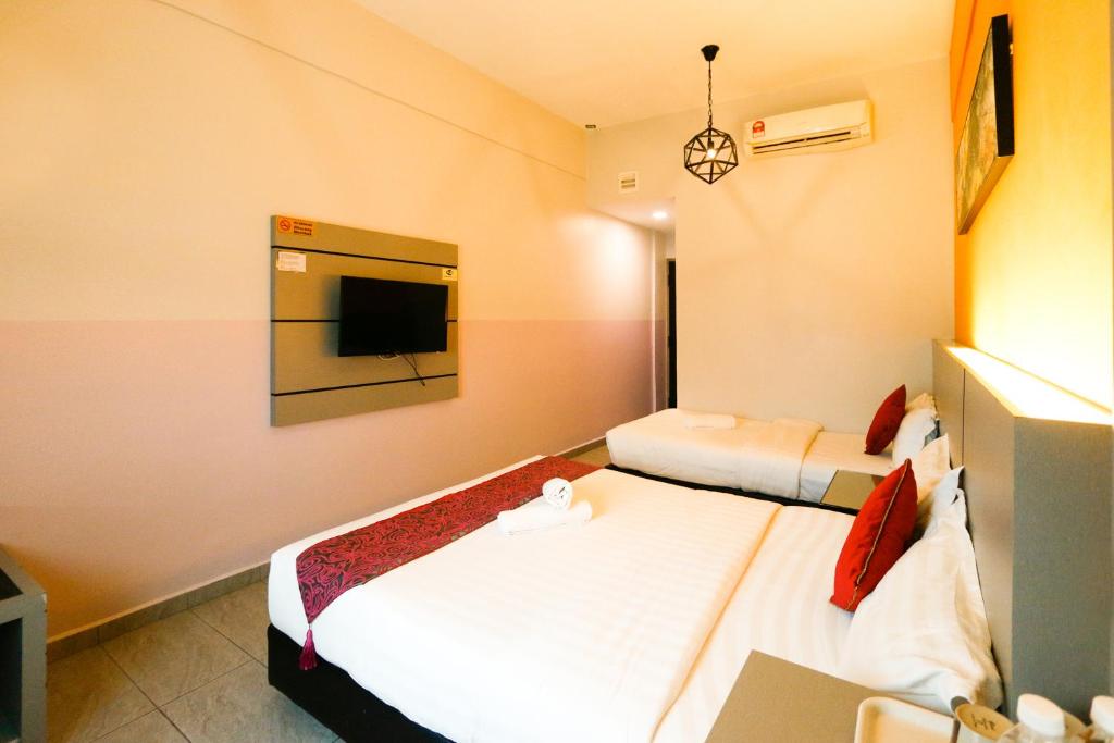 Postel nebo postele na pokoji v ubytování Travelland Hotel