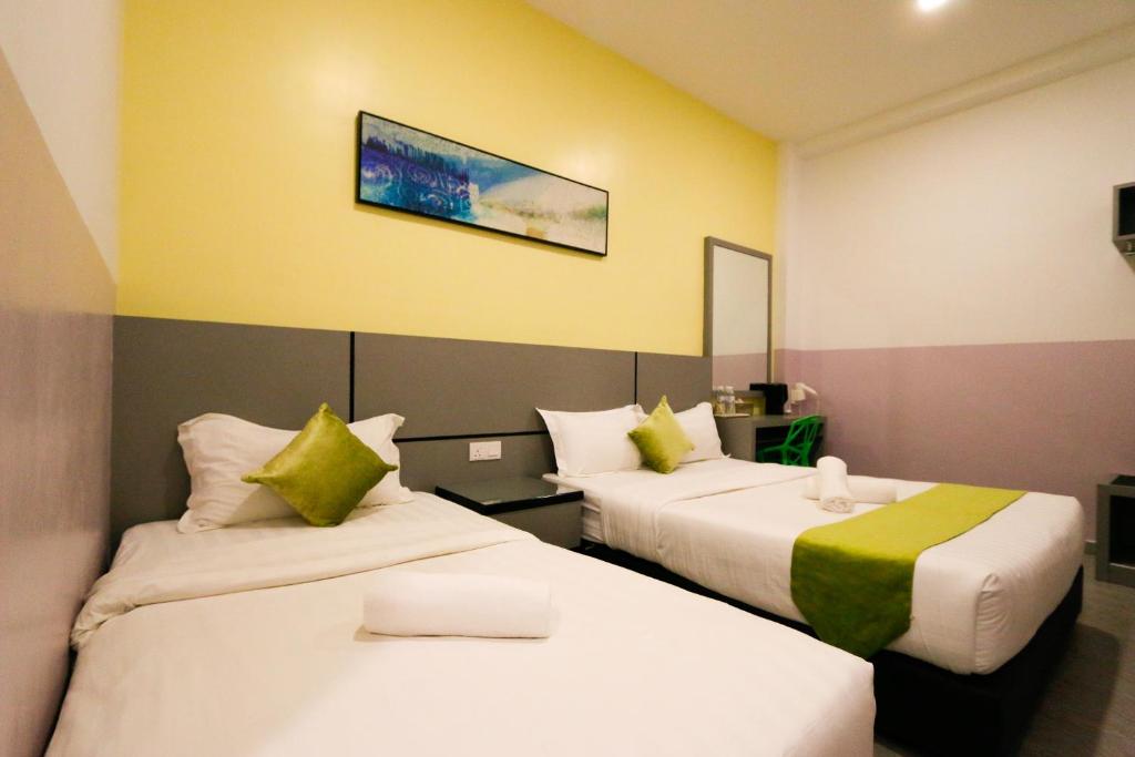 Postel nebo postele na pokoji v ubytování Travelland Hotel