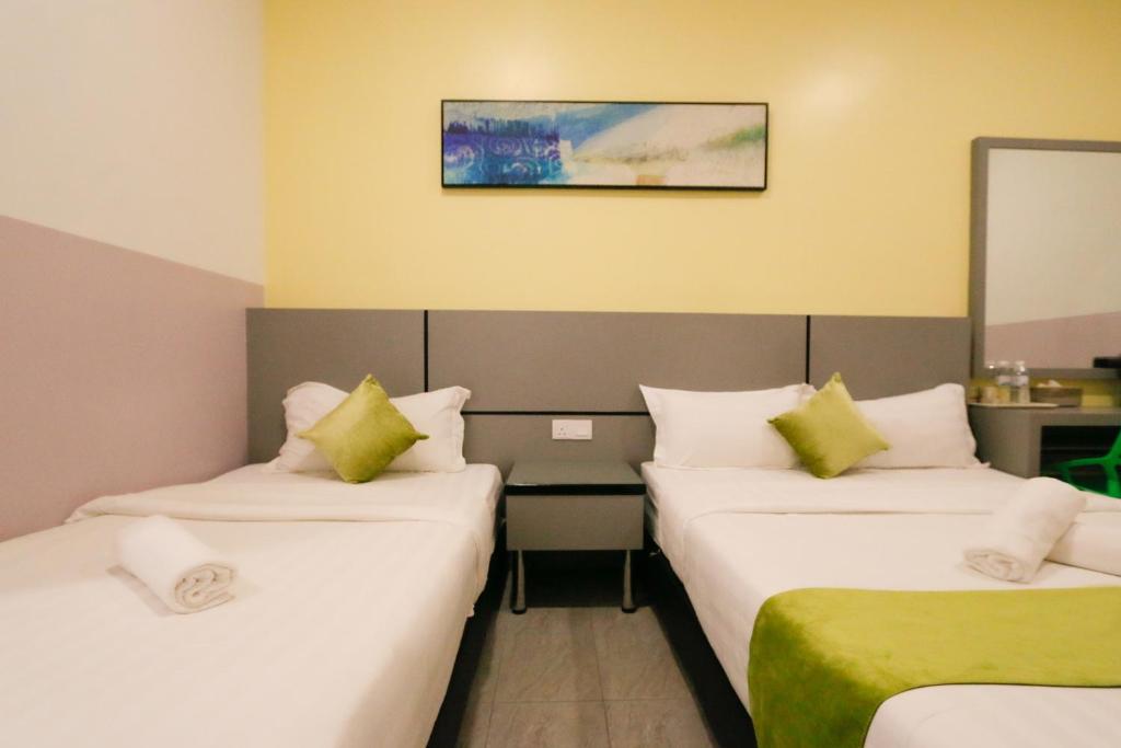 Postel nebo postele na pokoji v ubytování Travelland Hotel