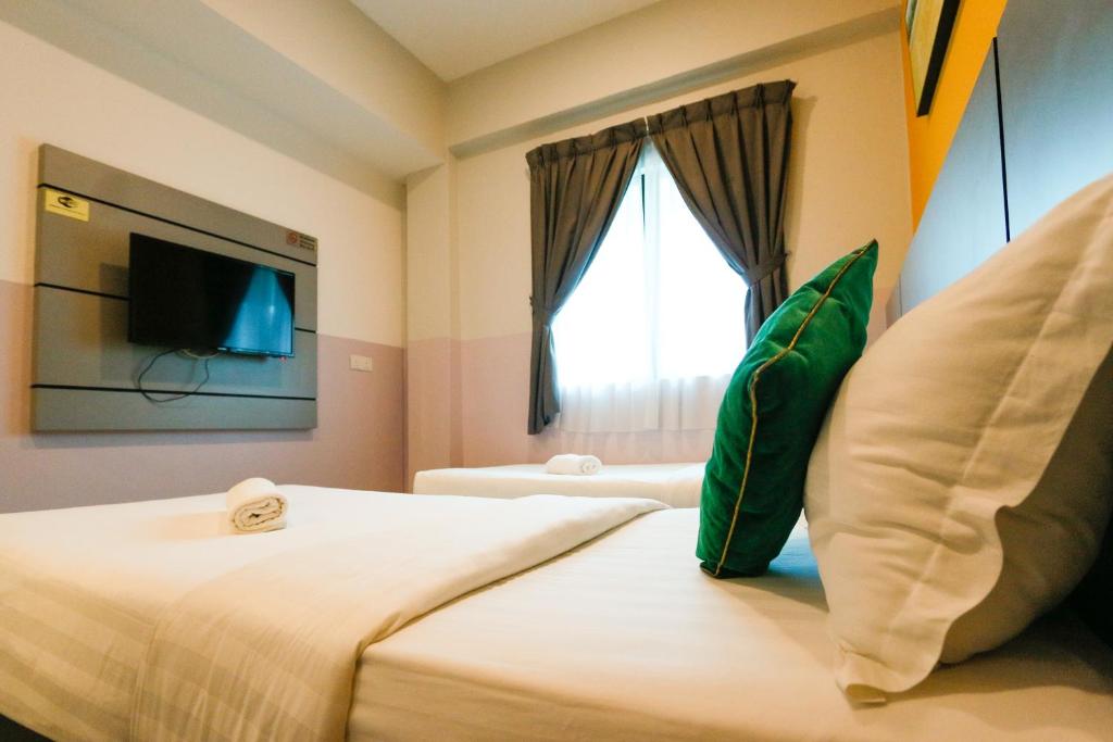 Postel nebo postele na pokoji v ubytování Travelland Hotel