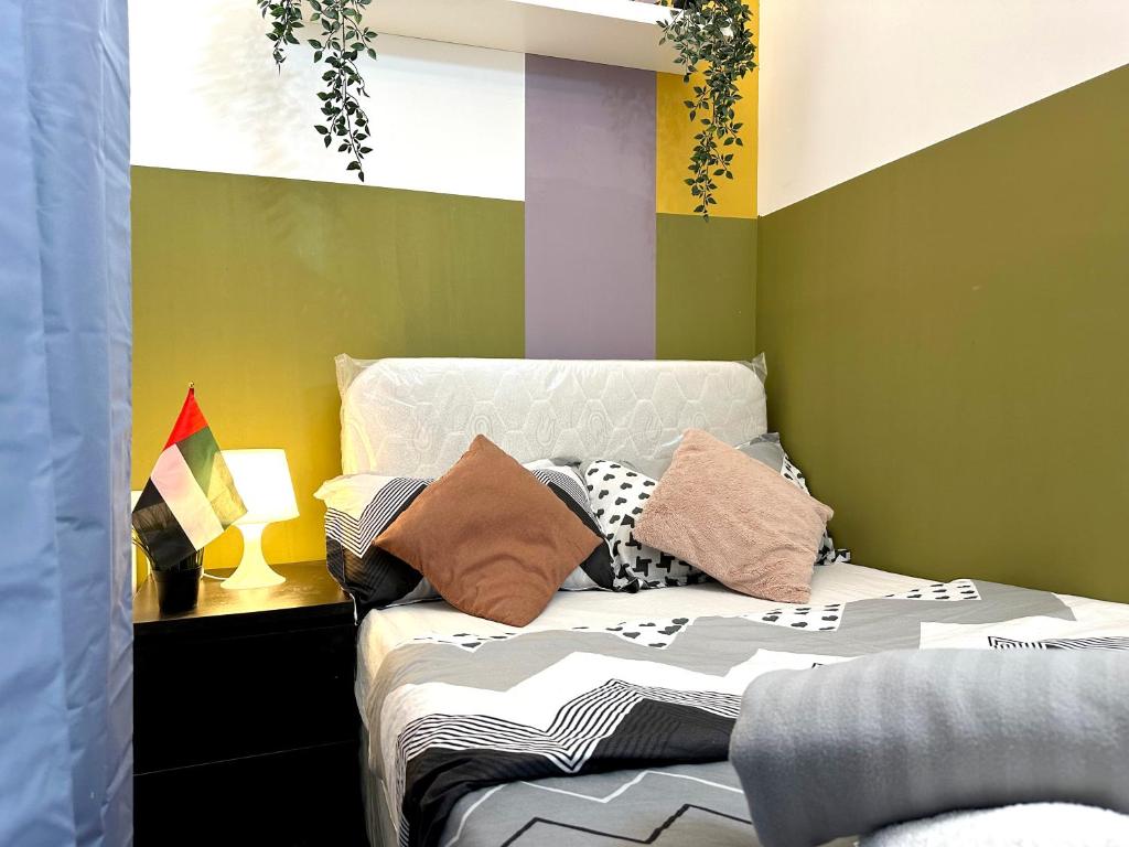 ein Schlafzimmer mit einem Bett mit Kissen darauf in der Unterkunft Double window Partition Room in Tecom Near Metro in Dubai