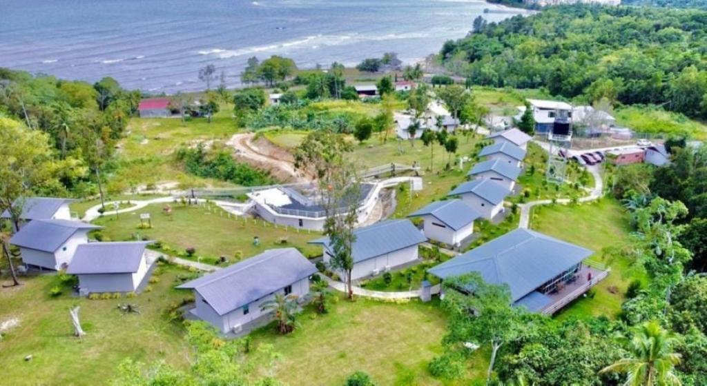 an aerial view of a house on a hill near the ocean at D View Holiday Homes in Kudat