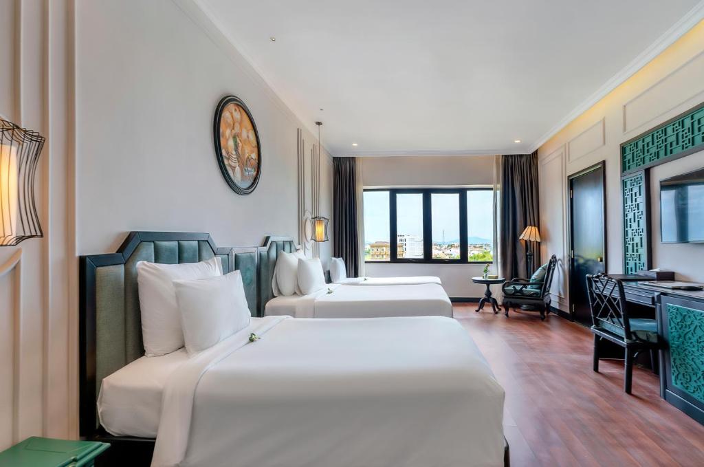 Postel nebo postele na pokoji v ubytování Hadana Boutique Resort Hoi An