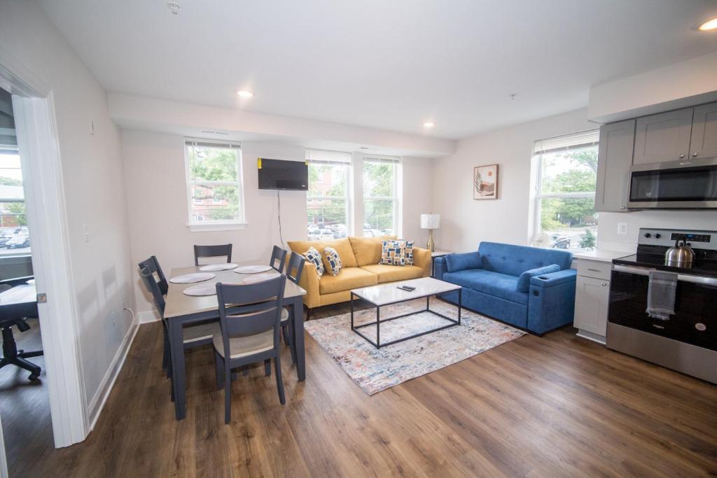 a living room with a couch and a table at The Oasis ;Luxury and Style in Washington, D.C.