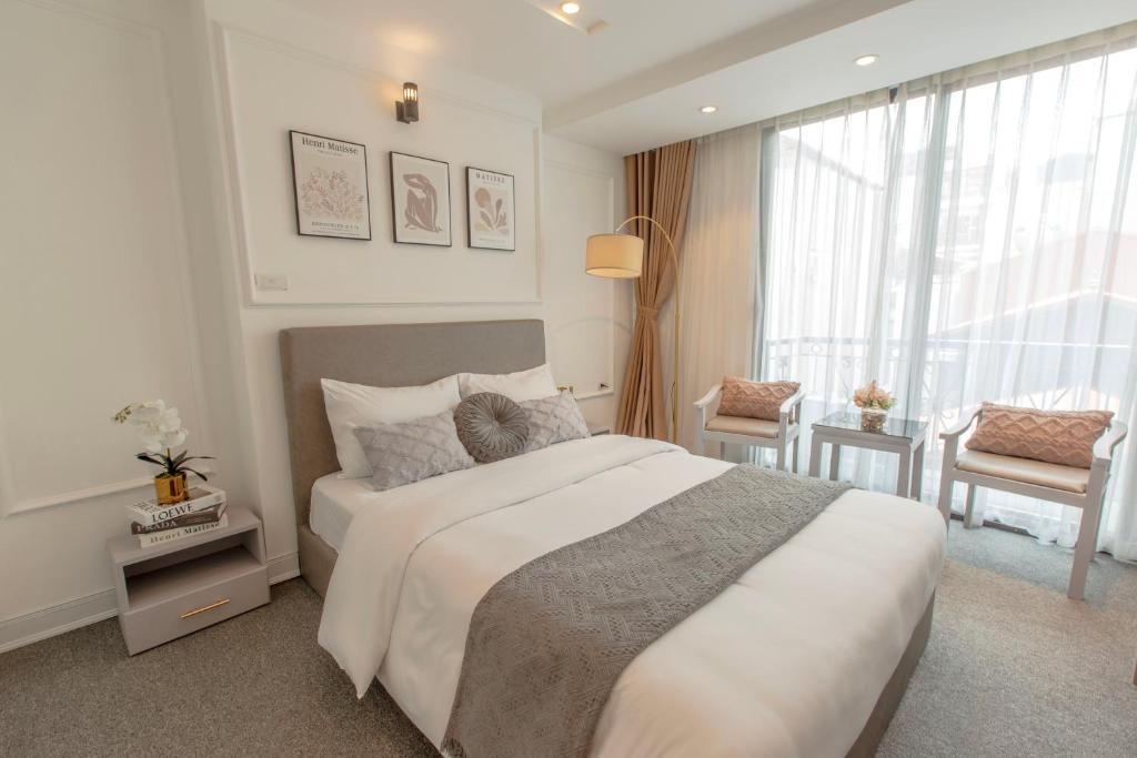 Postel nebo postele na pokoji v ubytování Keypad Hotel - 87 Nguyễn Khang