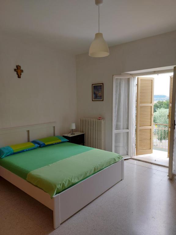 a bedroom with a large bed and a large window at Casa nel centro storico a Loreto, 2 km dal mare in Loreto