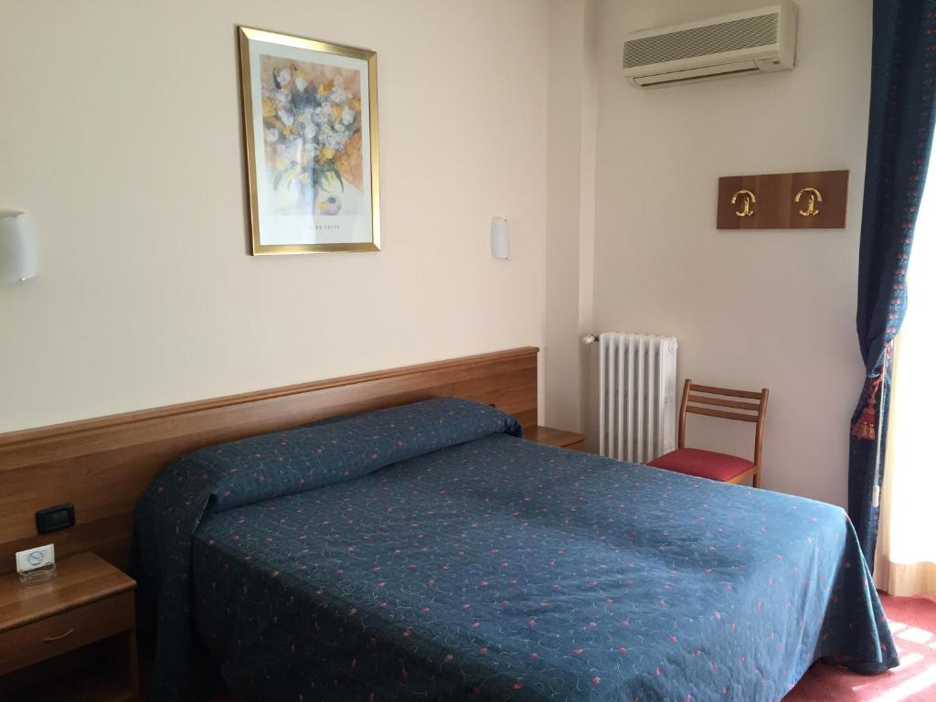 Postel nebo postele na pokoji v ubytování Hotel Arcobaleno