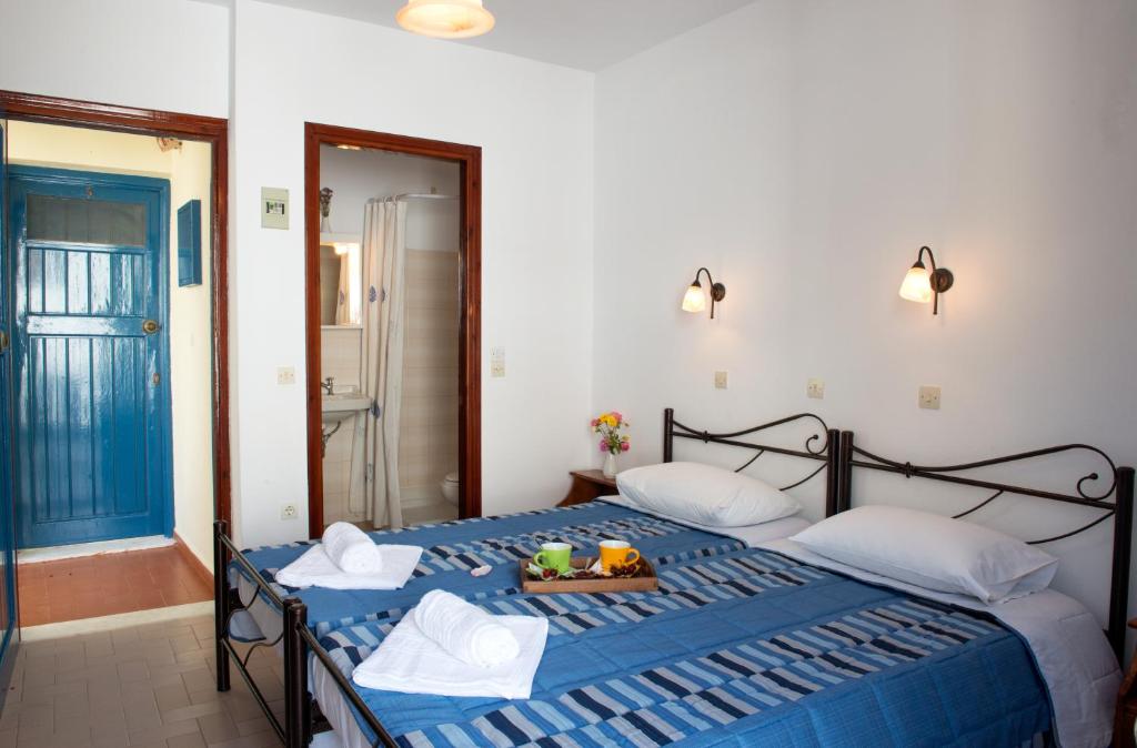 Cama ou camas em um quarto em Hotel Kyma