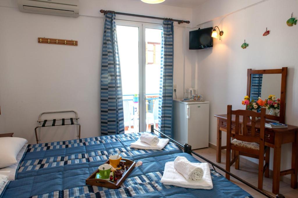 Cama ou camas em um quarto em Hotel Kyma