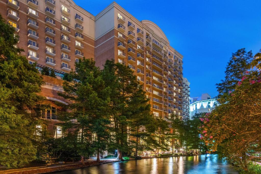 a river in a city with tall buildings at The Westin Riverwalk, San Antonio in San Antonio
