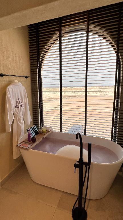 a large bath tub in a bathroom with a window at The Gate in Sur