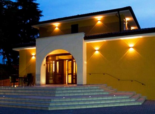 a house with stairs in front of it at night at Villa Del Poeta in Arquà Petrarca