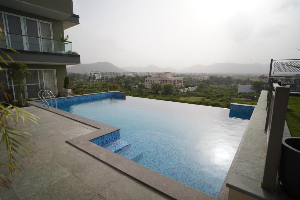 a swimming pool on the side of a building at SURAMYA-A Luxury Boutique Hotel in Udaipur