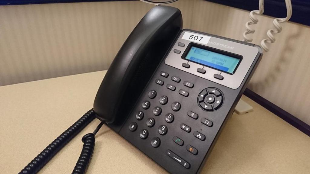 a black phone sitting on top of a desk at Toyoko Inn Osaka Itami Airport in Toyonaka