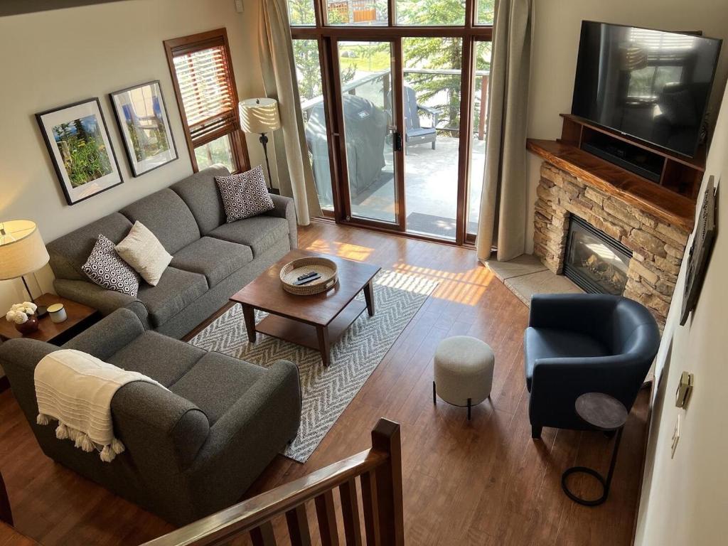 a living room with a couch and a fireplace at Trappers Landing #34 in Sun Peaks