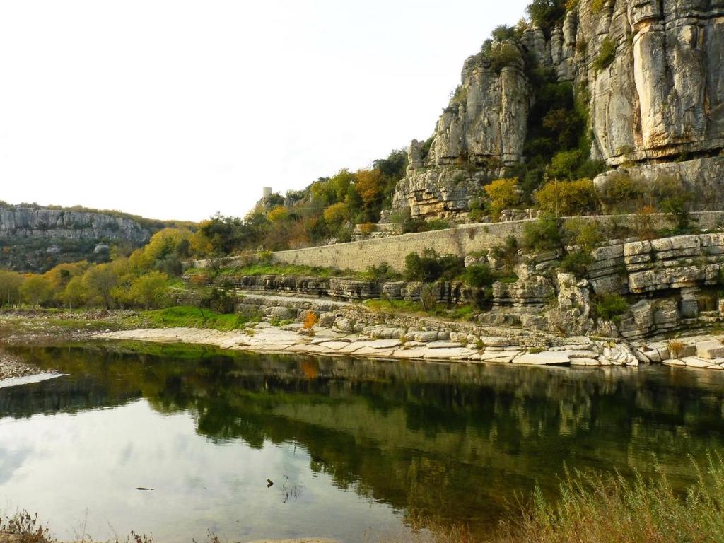 a body of water with a mountain in the background at Gîte Amour D&#39;ardèche in Saint-Sernin