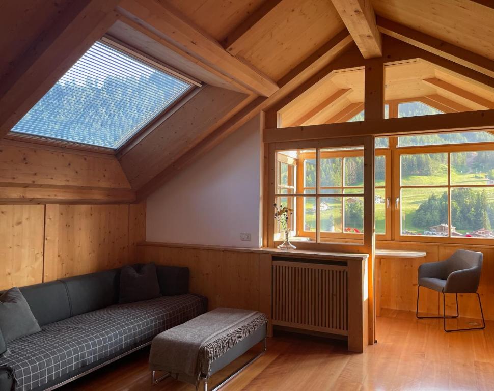 a living room with a couch and a window at Apartment Cesa Collina Superior in Ortisei