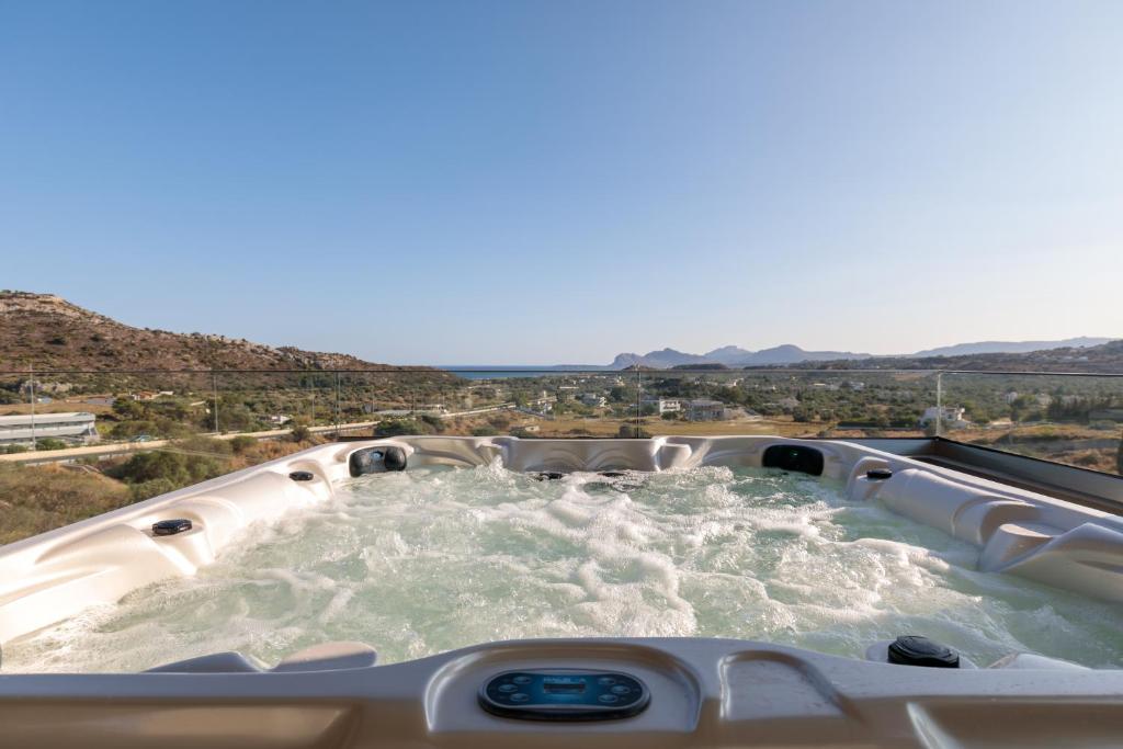 a hot tub with water in the middle of a desert at Marsane Luxury Appartments in Faliraki