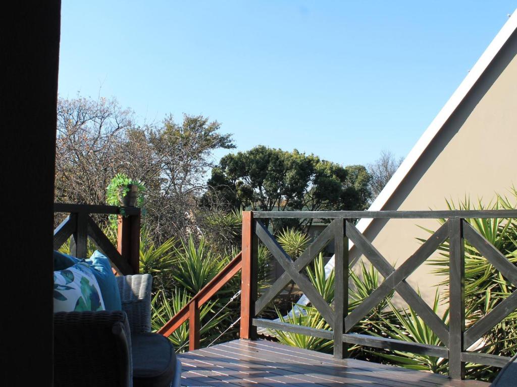 a view from the deck of a house with a fence at Wild Tree Lodge in Benoni