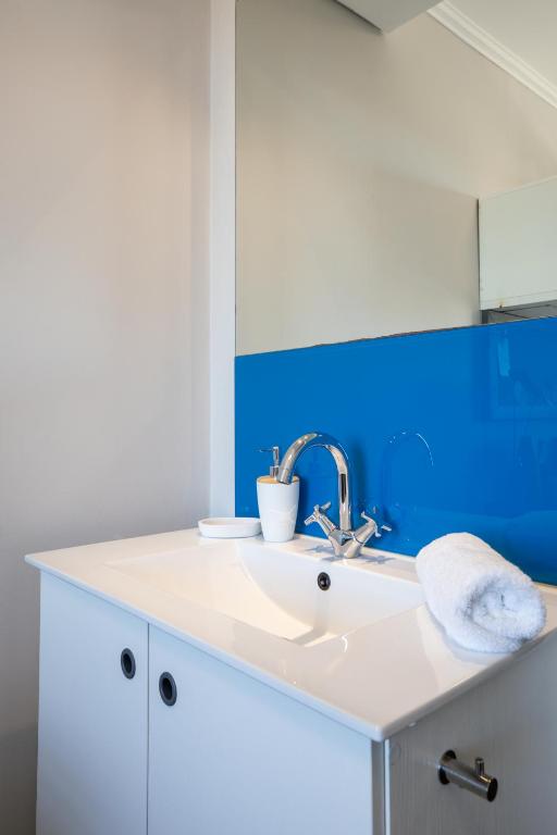 a bathroom with a sink and a blue wall at CampusKey Cape Town in Cape Town