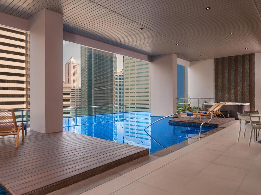 a swimming pool with a view of the city at Citadines Salcedo Makati in Manila