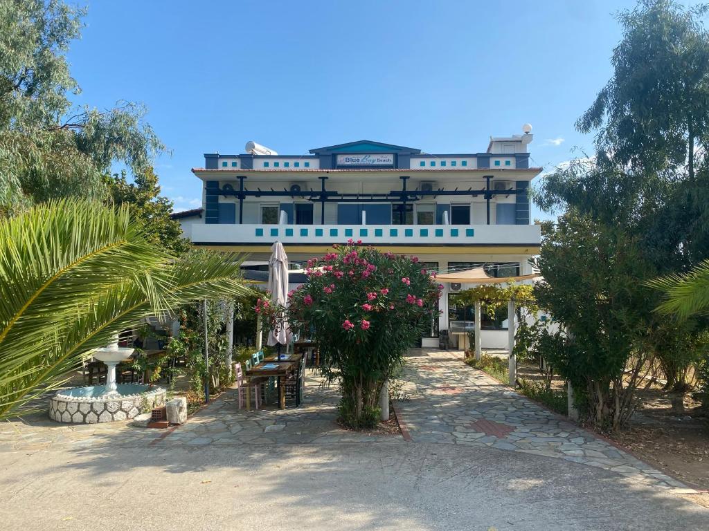 a large building with flowers in front of it at Blue Bay Beach Hotel in Koinyra