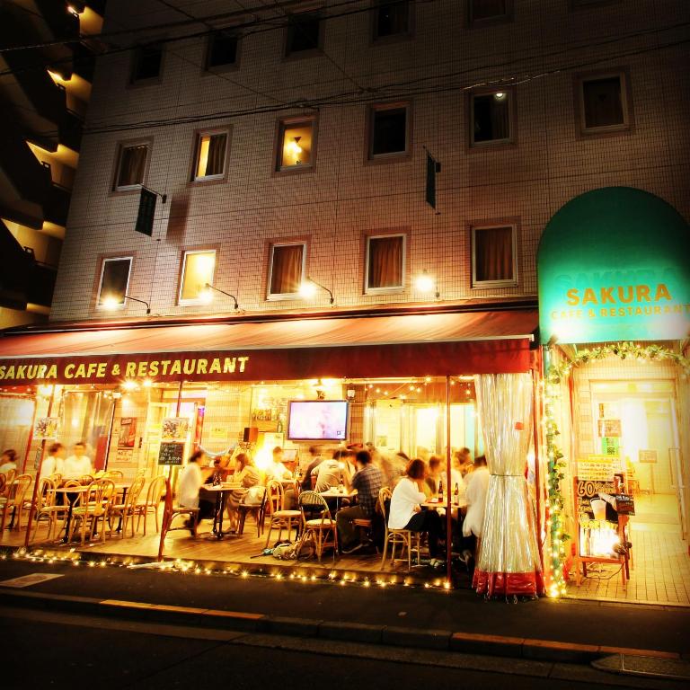 a group of people sitting at a restaurant at night at Sakura Hotel Ikebukuro in Tokyo